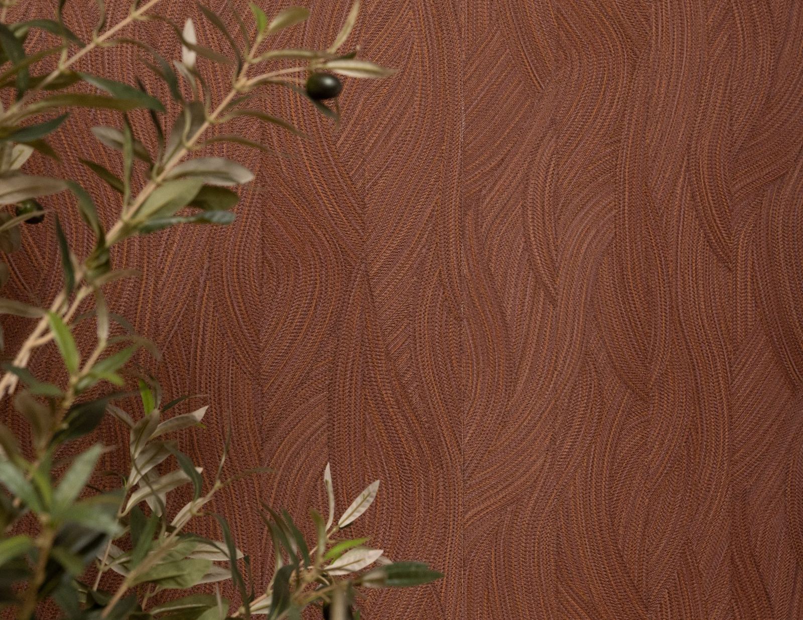 An olive branch in fruit, silvered leaves and a single dark olive, against terracotta wallpaper with a flowing leaf-and-wave motif