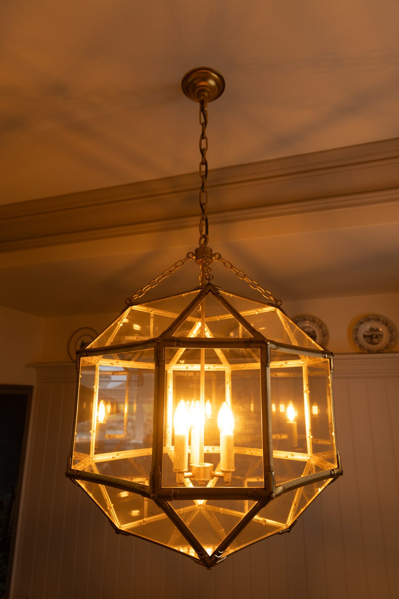 A geometric brass and glass pendant above the Bamburgh dining table