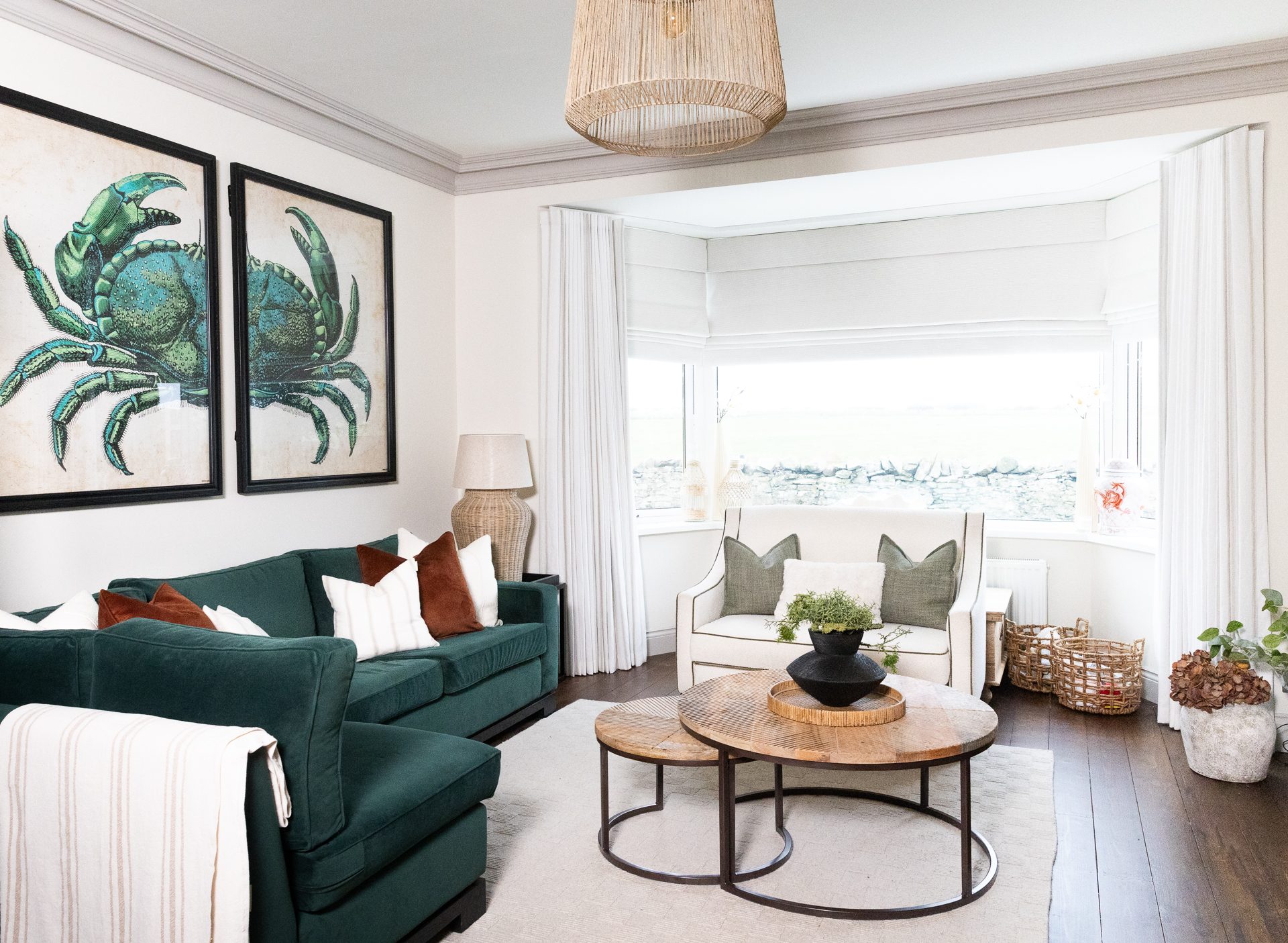 Coastal retreat near Bamburgh, living room with green velvet sofa and sea view, designed by Lauren Reece