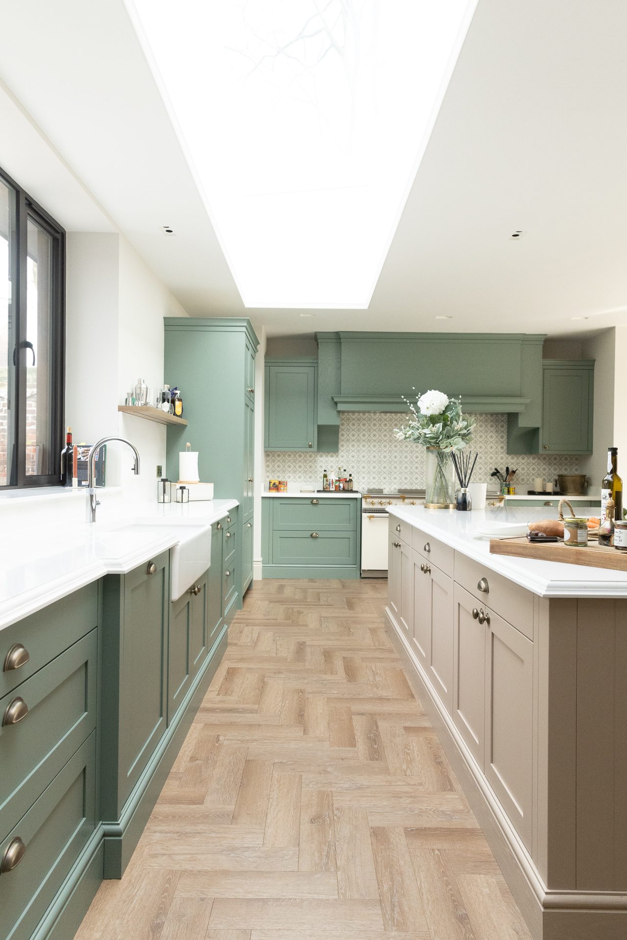 Sage green galley kitchen with skylights at Elmfield Road