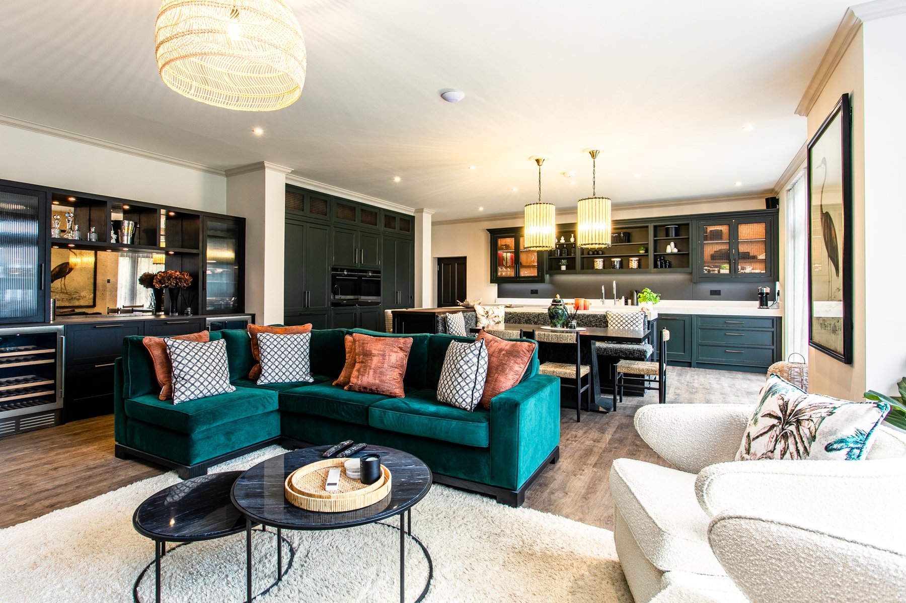 Alternate angle of the same open-plan room, more of the kitchen island and pendants visible