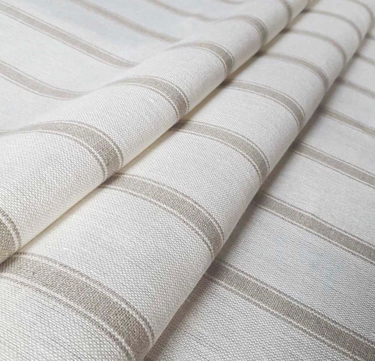 A close fold of cream linen with subtle taupe stripe — utility ticking from Ian Mankin in an Aubury scheme